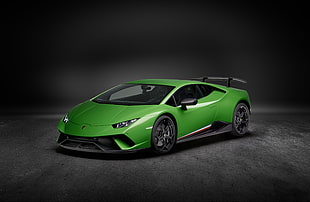 photo of green luxury car against gray background