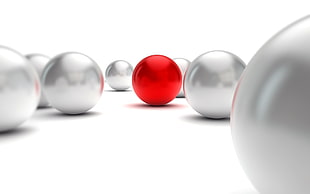 closeup photo of white and red balls on white surface