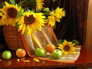 yellow artificial sunflowers and apple fruits