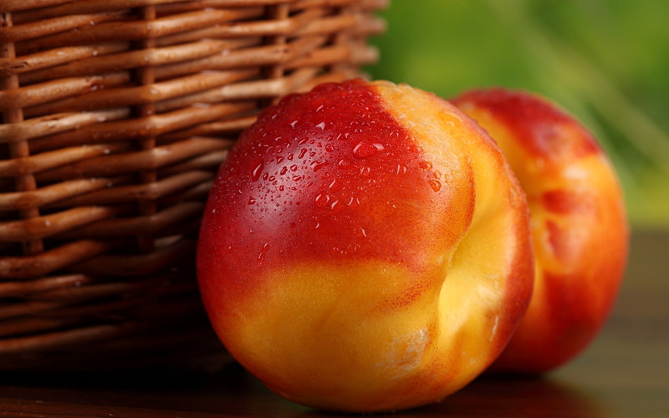 two red apples near brown basket HD wallpaper