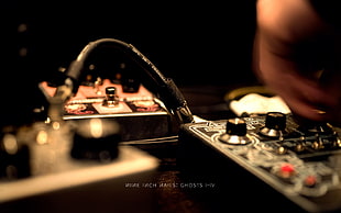 shallow focus photography of person holding audio mixer