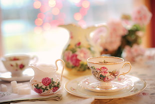 white and pink floral ceramic cups and saucers on table HD wallpaper