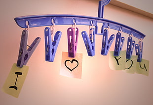 blue clothes hanger with clips