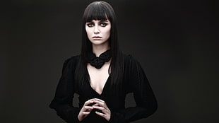 woman wearing black in dark surface