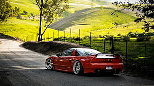 orange Acura NSX on countryside road during daytime
