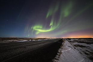 concrete roads across northern lights, iceland
