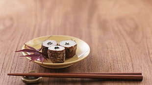 three sushi on ceramic plate