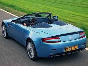 photography of blue Aston Martin Vanquish convertible coupe
