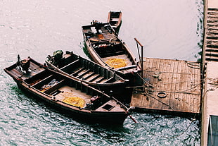 three brown outboard boats