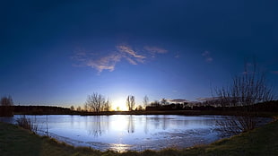 photo of lake with sun set