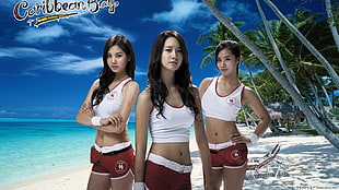woman wearing white crop tank top and red dolphin shorts standing between other two girls