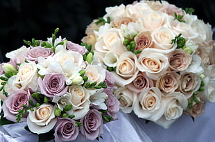 two white-and-pink and white-and-purple Rose flower bouquets