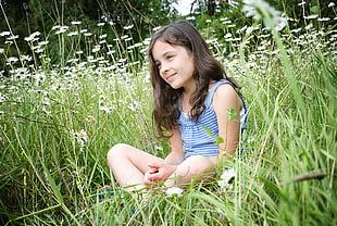 girl on blue stripped tank top surrounded by green grass and white flower during daytime HD wallpaper