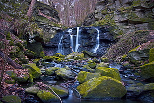 panoramic view of waterfalls with green moss rocks