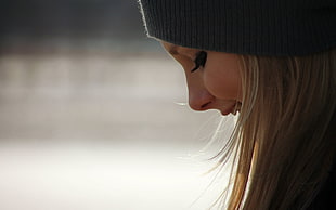 selective focus photography of woman wearing black knit hat