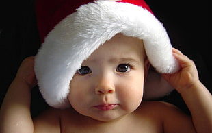 baby's wearing Santa Claus hat HD wallpaper
