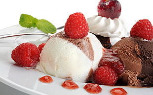 vanilla and chocolate ice cream with raspberries on top