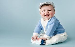 toddler sitting while laughing photo