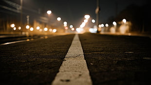 road white line in close-up photo at night