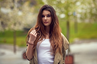 woman wearing brown jacket and white top