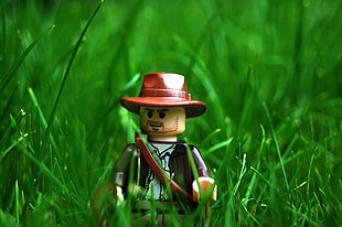 cowboy Lego toy on grass macro photography HD wallpaper