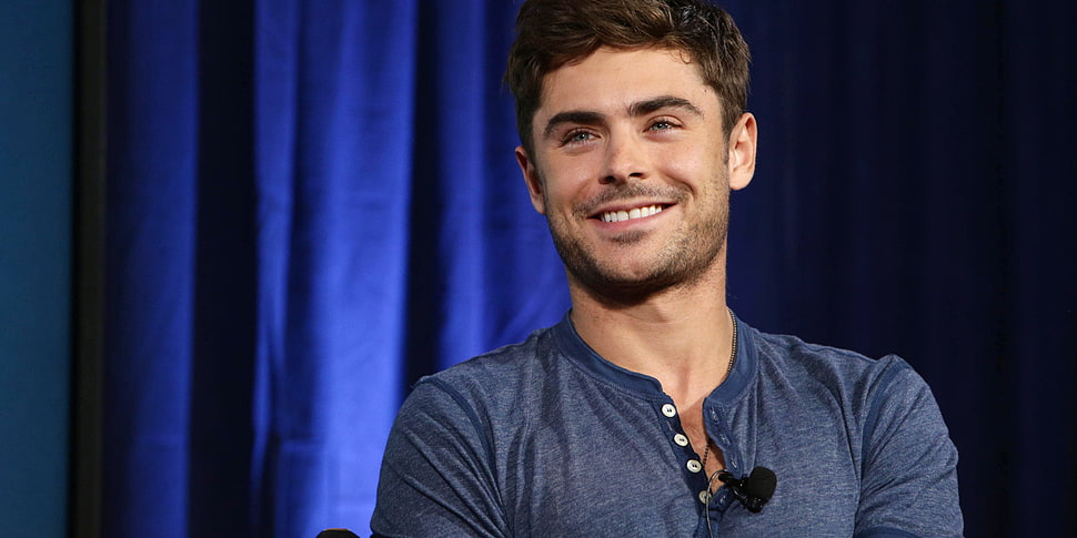 smiling man in blue henley shirt HD wallpaper