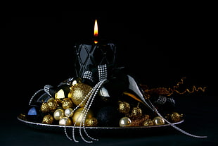 gold baubles and black pillar candle