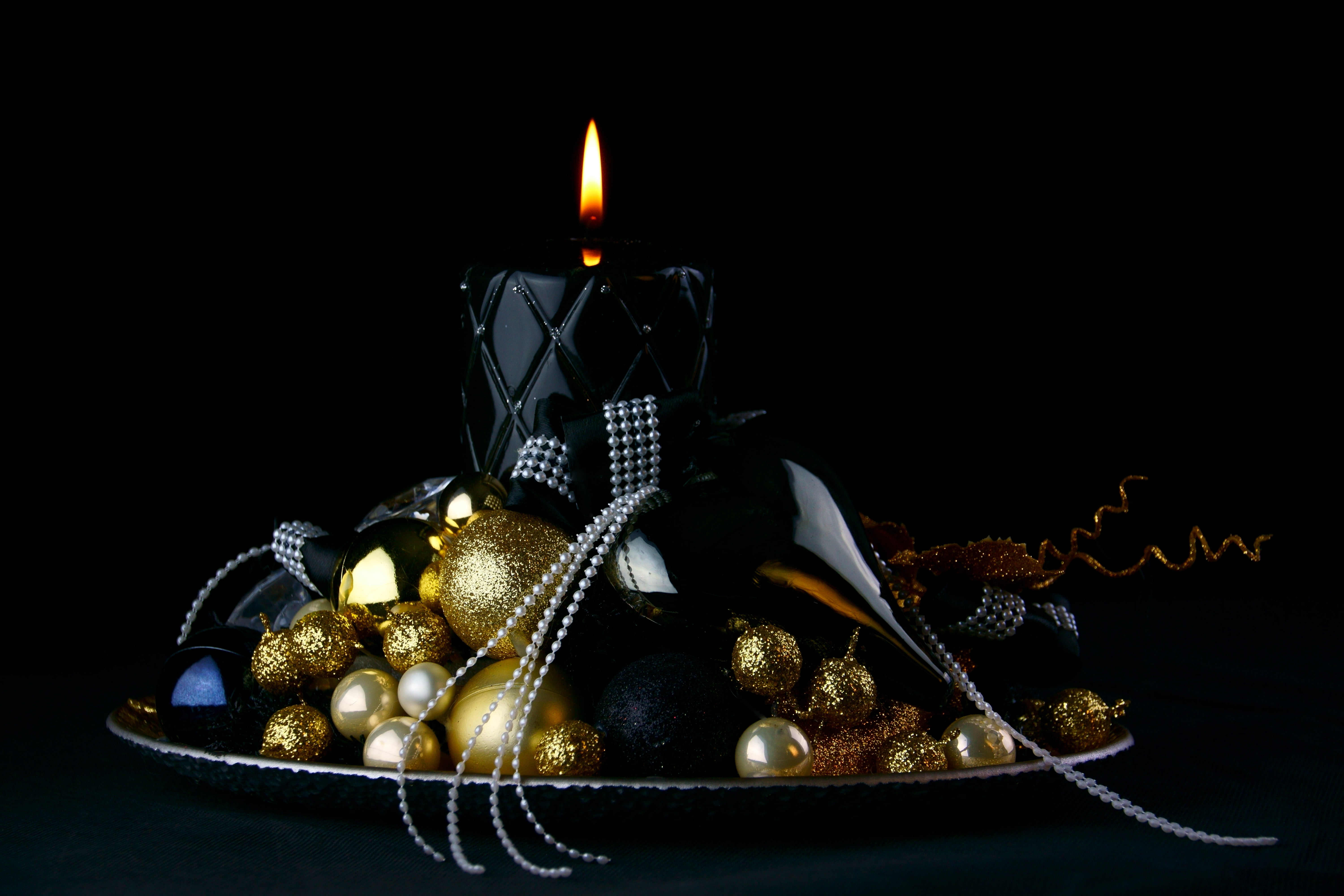 gold baubles and black pillar candle