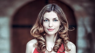 portrait photography of woman in red sleeveless top