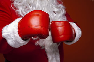photo of Santa Claus wearing red boxing gloves