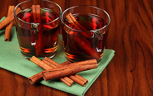 cinnamon beside drinking glass with liquid