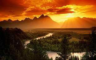 winding river on valley during sunset