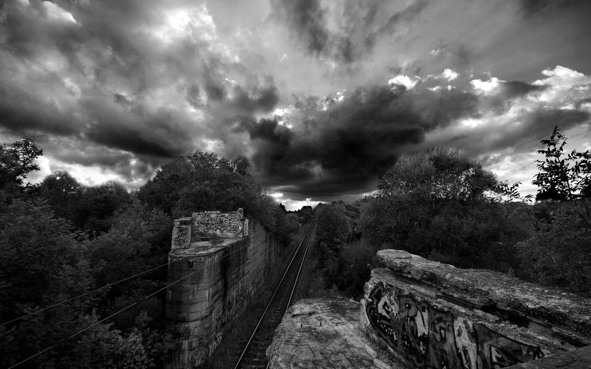 train tracks in grayscale photography
