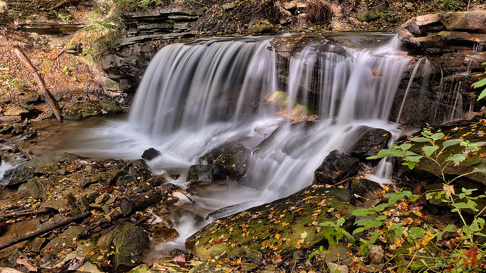 Downstream Waterfall on Black Rocks during Day HD wallpaper
