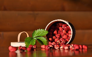red strawberries on brown wooden table
