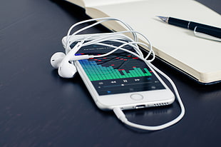 silver iPhone 6 with EarPods beside notebook HD wallpaper
