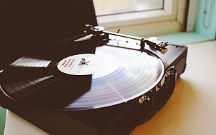 black vinyl player on brown surface