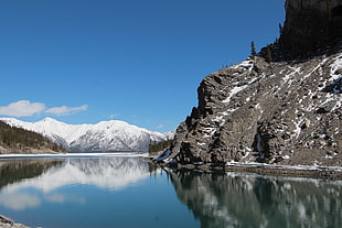 snow capped mountain near lake under blue sky during daytime, spray lakes, canada