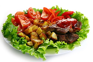 sliced grilled meat and tomatoes served on white ceramic plate