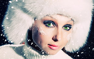 closeup photography of woman's face with fur cap