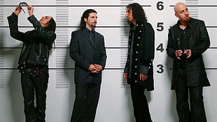 four man wearing black coats