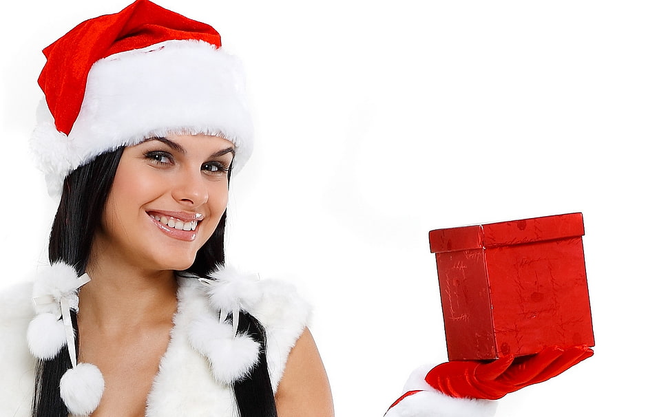 woman wearing Christmas hat and holding gift box HD wallpaper