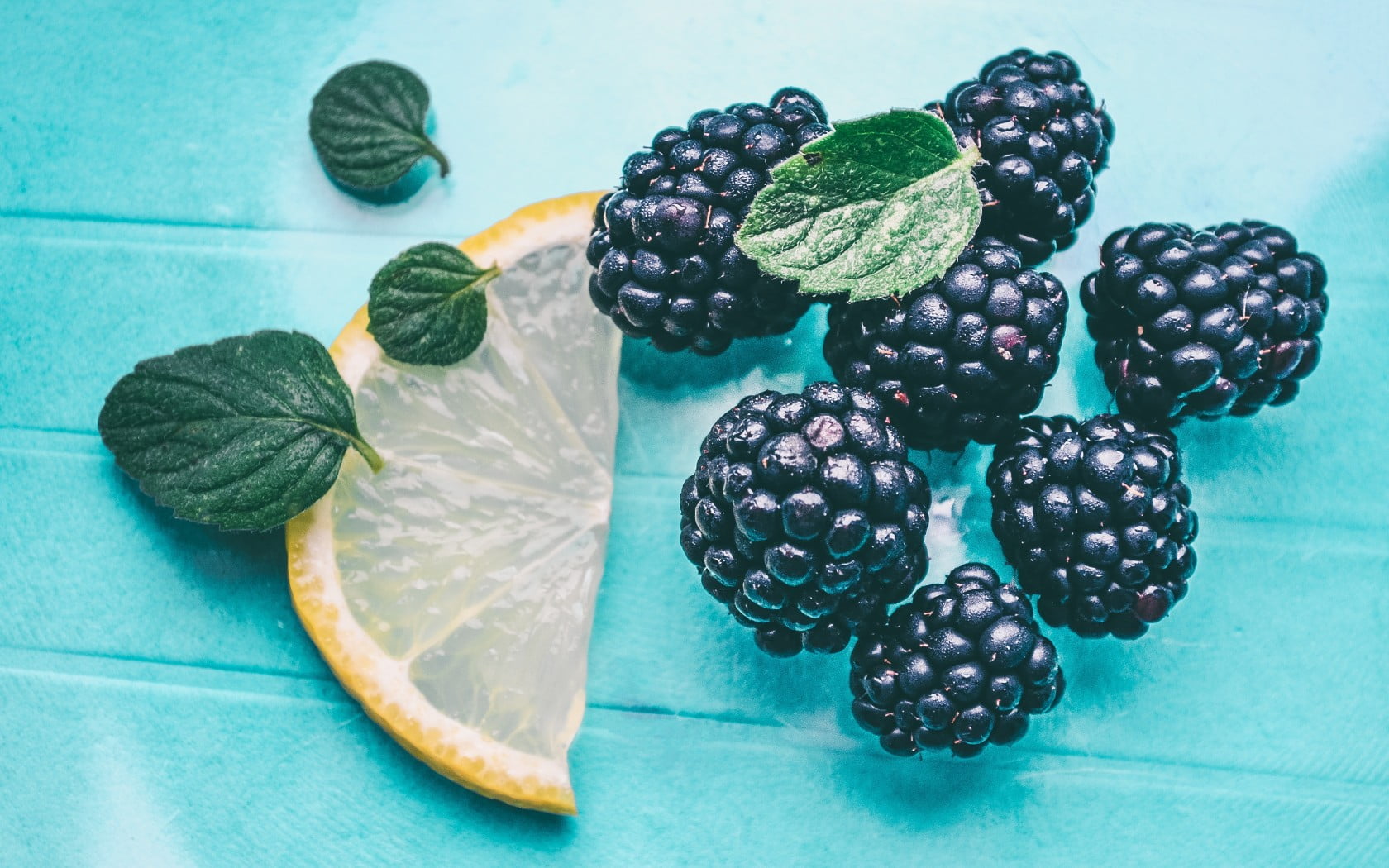 blue fruit with lemon and leaves