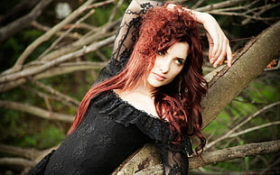 red haired woman in black scoop-neck lace dress