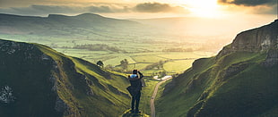 man taking photo of hills, ultra-wide, landscape