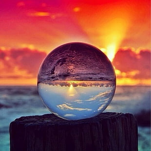 sunrise reflecting on clear glass water globe HD wallpaper