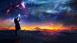 woman on mountain looking at starry night