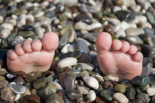 human feet on pebbles