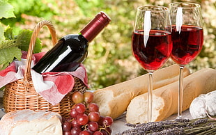 two wine glasses filled with red wine beside bread HD wallpaper