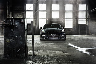 black car inside warehouse during daytime